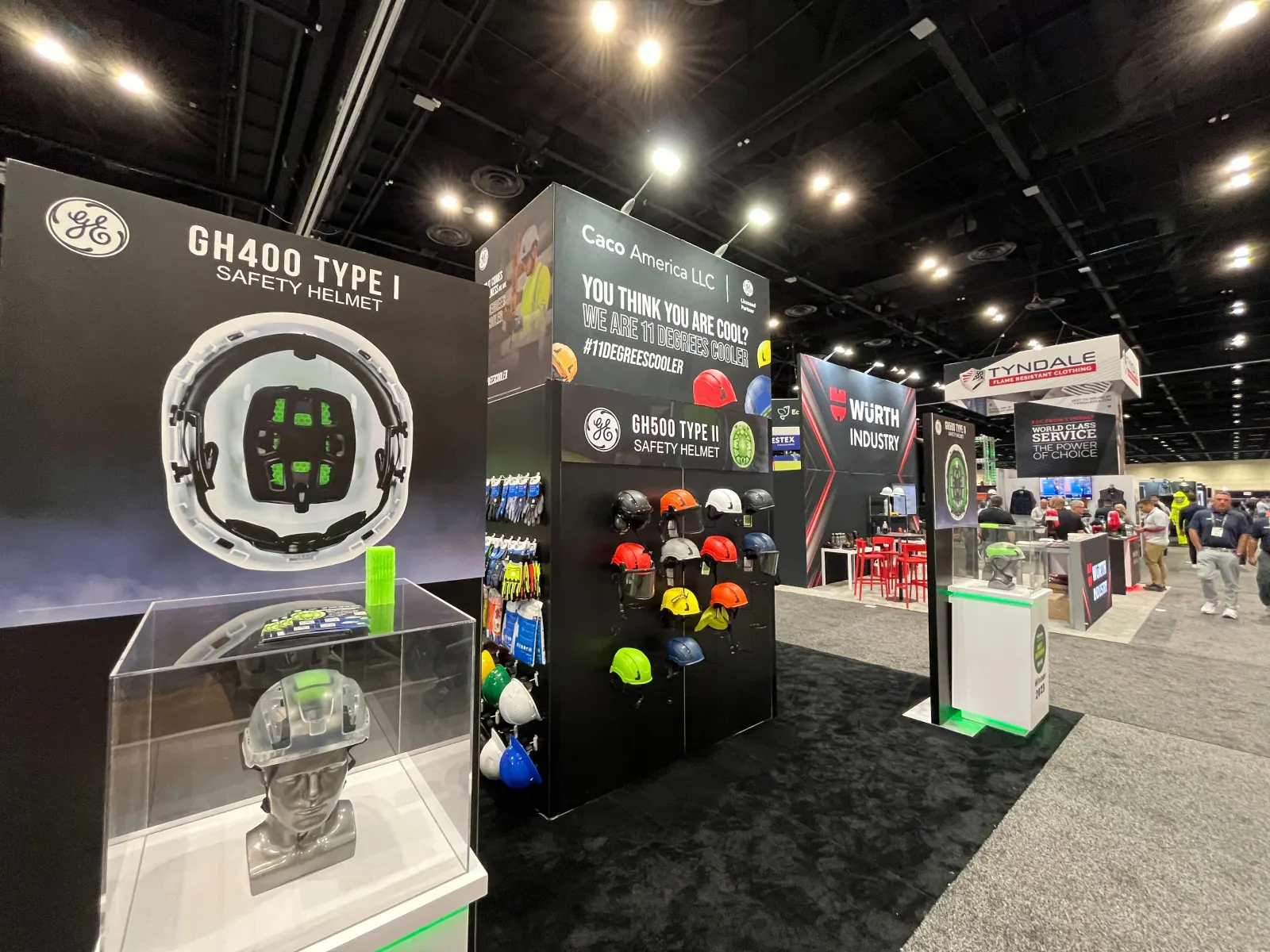 A display booth showcasing helmets at an expo hall.