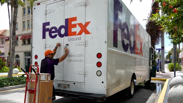 A FedEx worker makes a delivery on September 16, 2022 in Miami Beach, Florida.