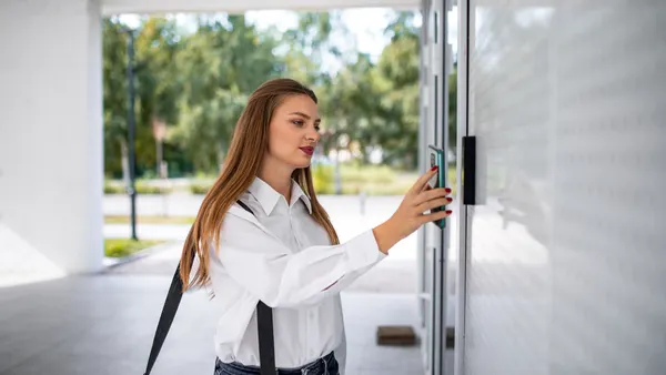 Business woman open the office door.