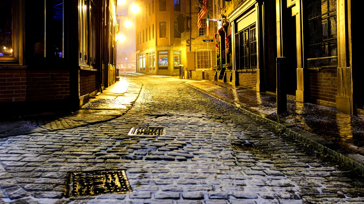 Snow-covered cobblestoned alley in Boston.