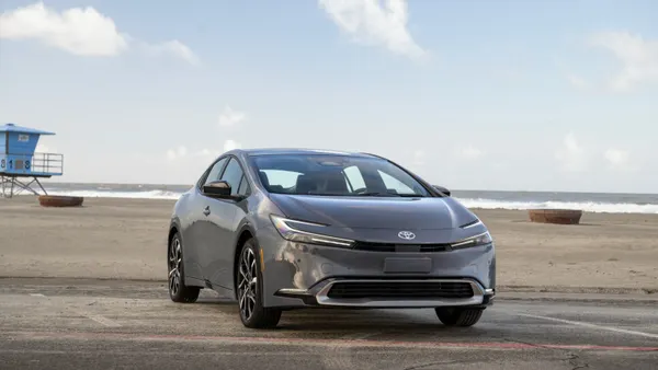 A gray 2026 Toyota Prius plug-in hybrid parked near a beach.