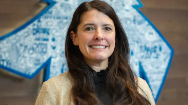 An image of a person smiling at the camera.