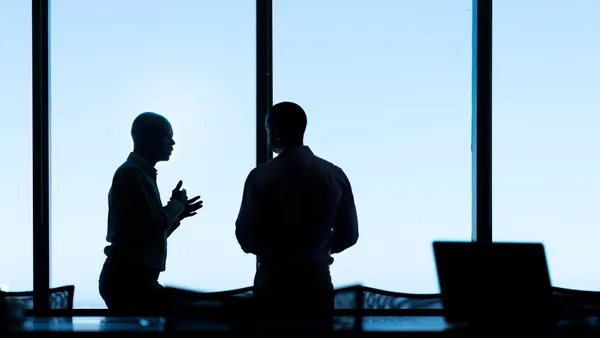 a high contrast image of two executives in a boardroom