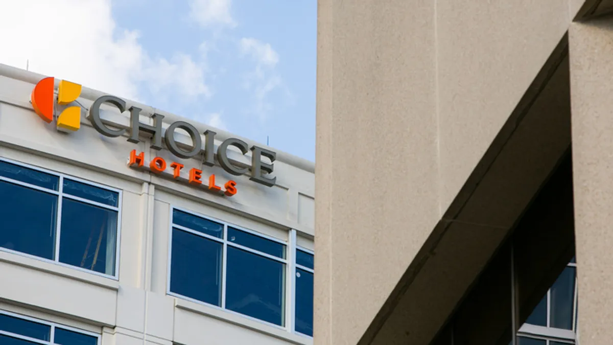 An image of the Choice Hotels logo on the exterior of a building.