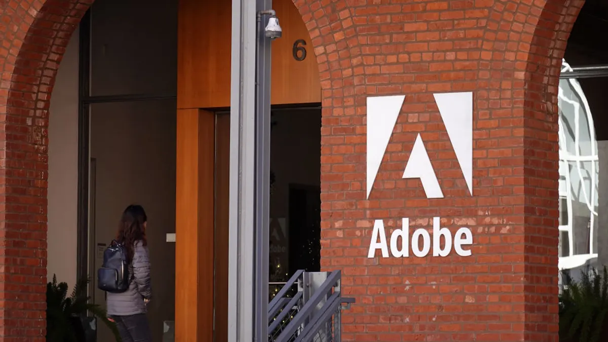 an exterior shot of a brick building with Adobe logo in white letters