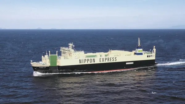 A container vessel traveling through the ocean.