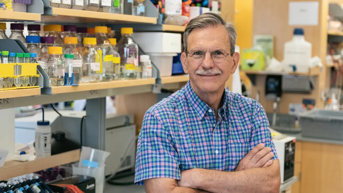 Tim Springer, a Harvard University professor, smiles at the camera in his lab.