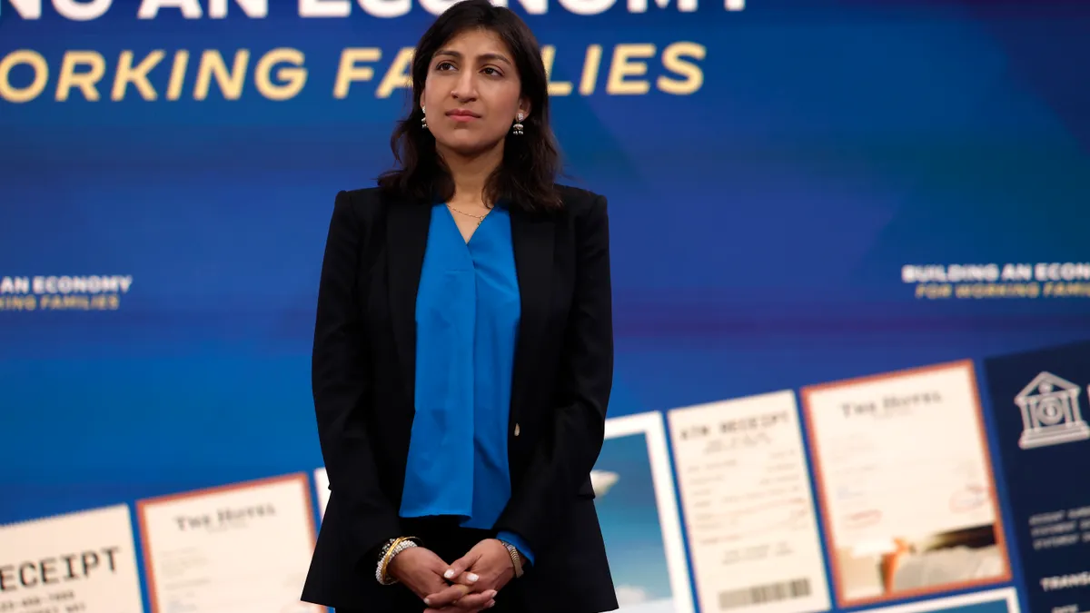 Federal Trade Commission Chair Lina Khan listens as U.S. President Joe Biden delivers remarks on the economy in the Eisenhower Executive Office Building on October 26, 2022 in Washington, DC.