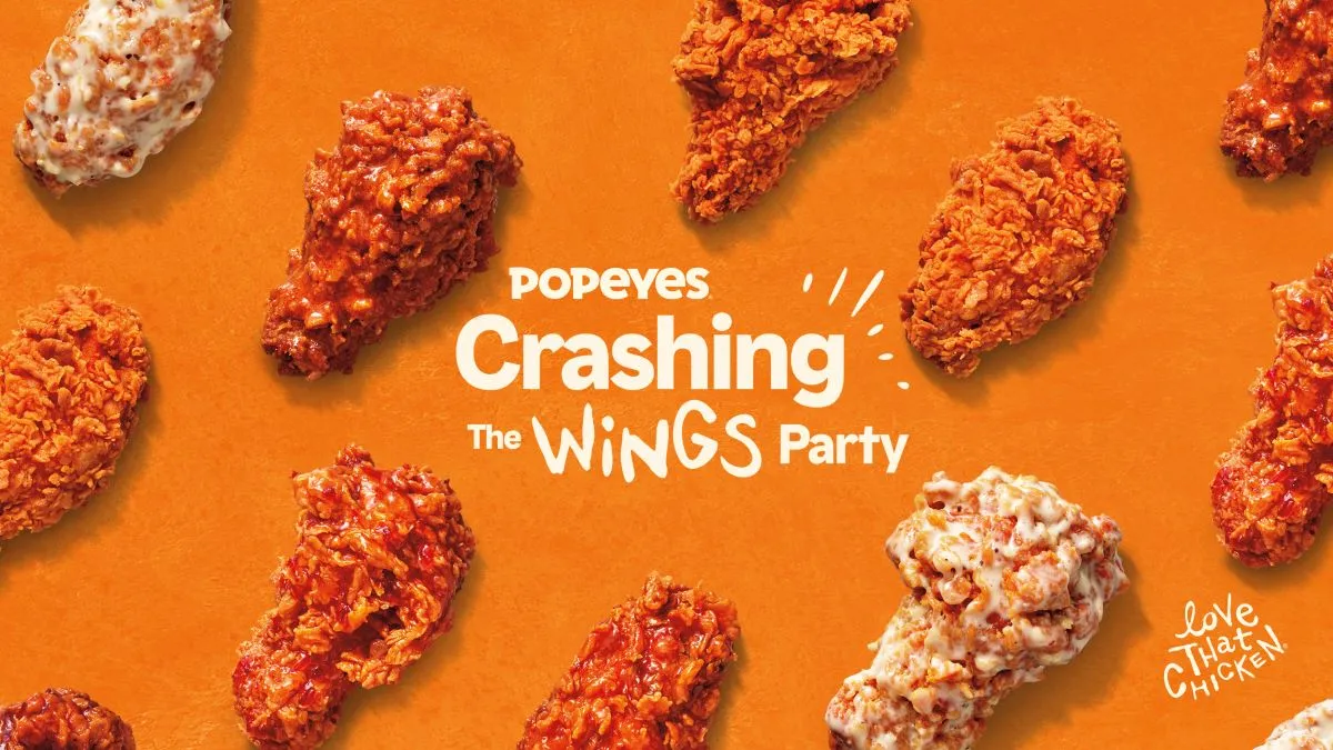 An image of Popeyes' five wings flavors on an orange background