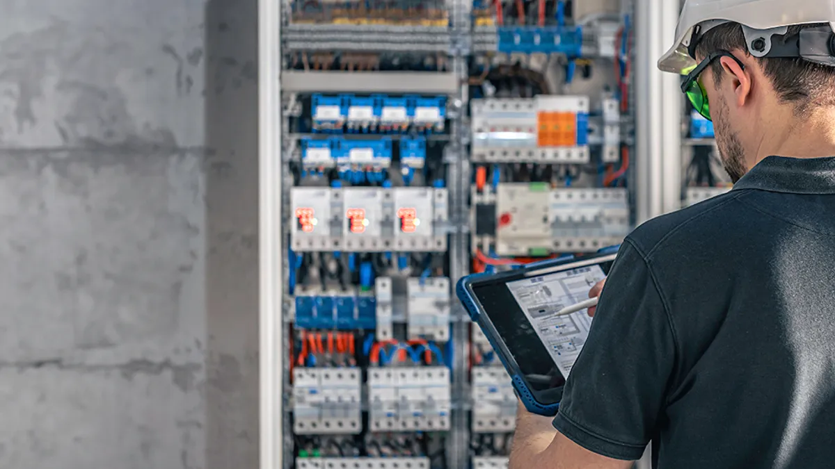 Electrician working on electrical fuses.