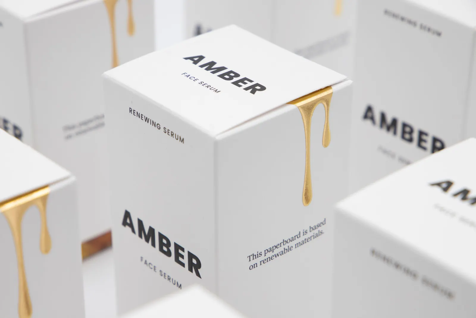Close-up shot of white product boxes that say &quot;face serum&quot; on them.