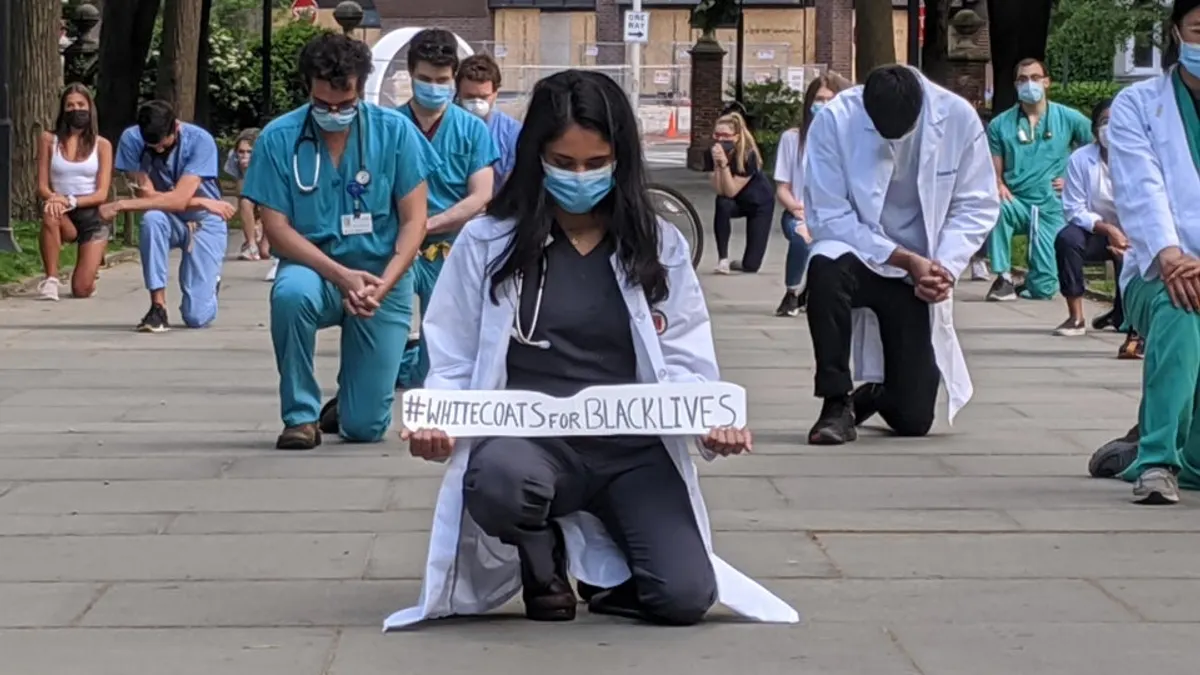 Philadelphia providers kneel on Sunday, May 31, 2020, to remember George Floyd, an unarmed black man who died in police custody.