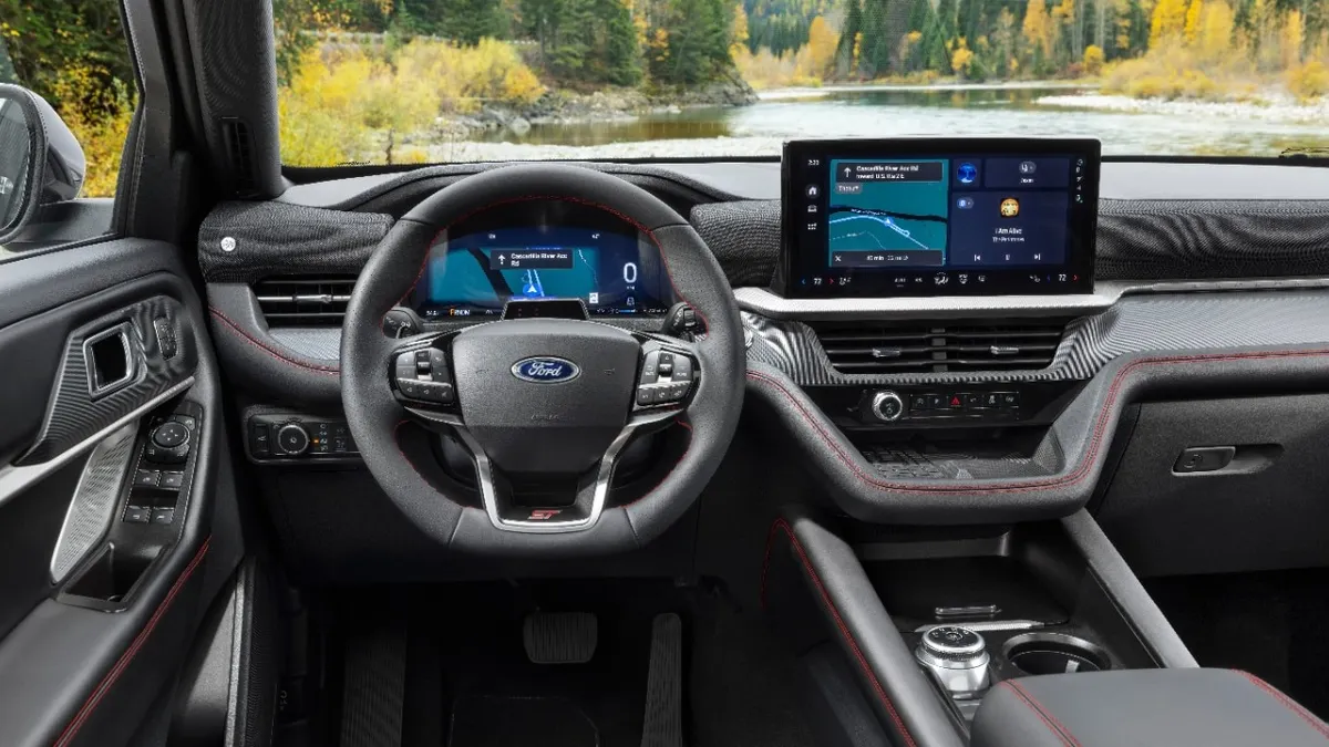 The interior of a 2025 Ford Explorer SUV showing the steering wheel, instrument cluster and center display screen.