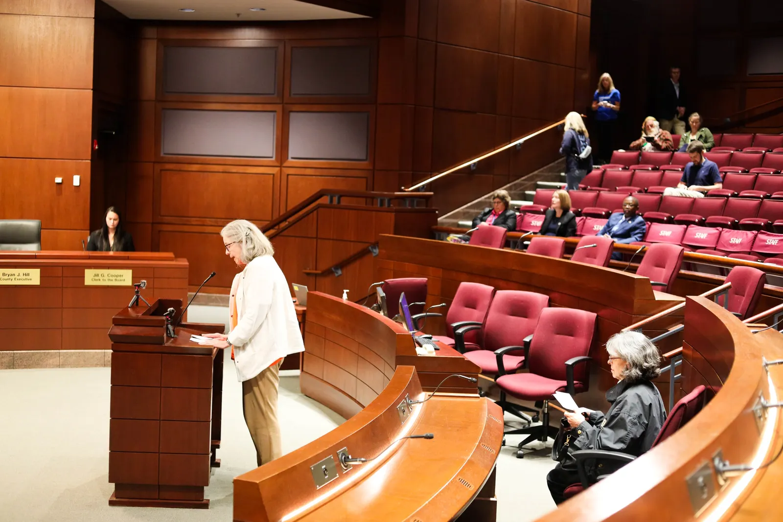 A speaker addresses Virginia State Corporation Commission Chief Hearing Examiner Mathias Roussy at an Oct. 9, 2026, local hearing about the proposed merger between Dominion Energy and NextEra.