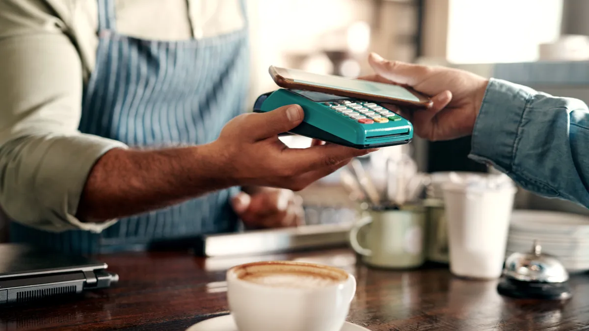 A customer pays for a purchase with a mobile device