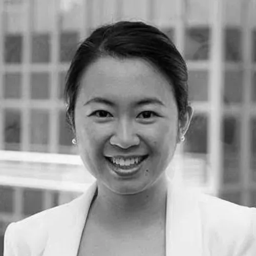 A headshot of a woman in black and white