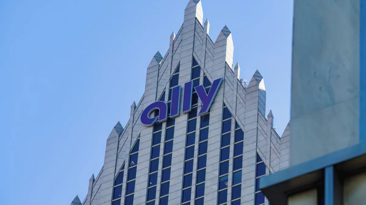 A skyscraper with the word "Ally" on it is shown, with blue sky behind.