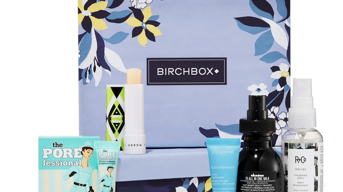 Photo of a blue box with the name "Birchbox" on it, and several bottles of beauty products