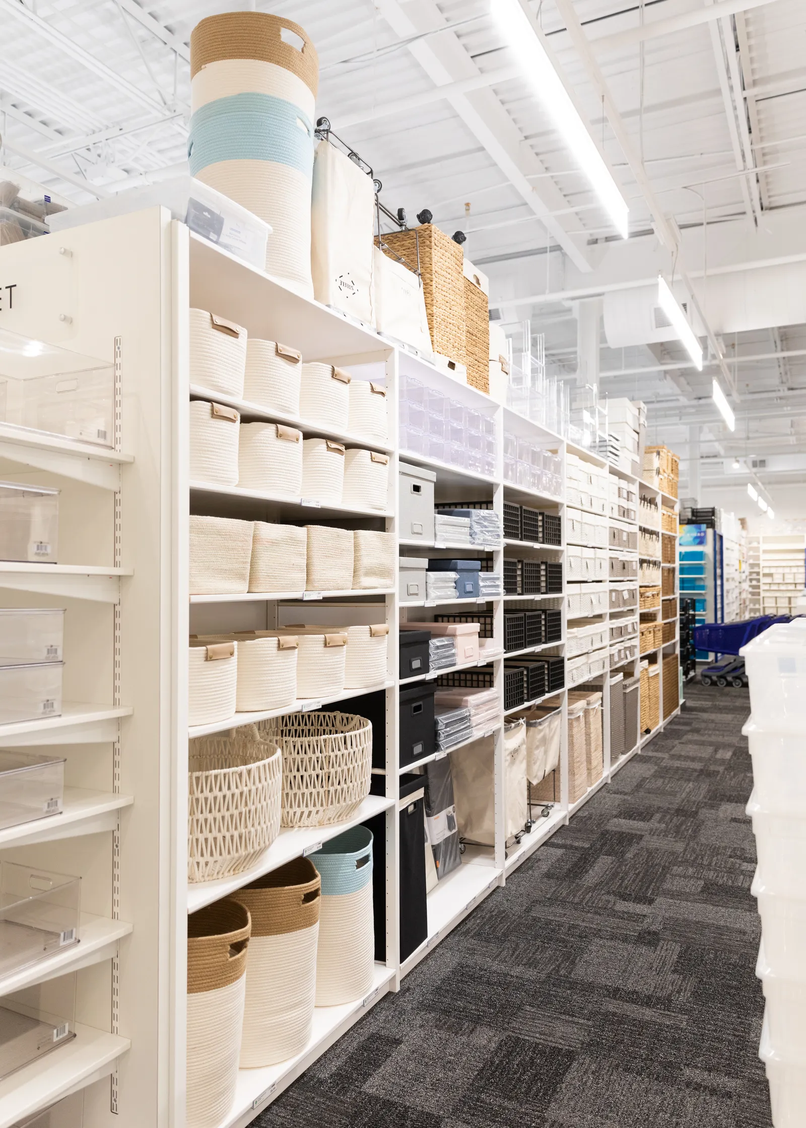 A shelf displaying a grouping of storage containers inside one of The Container Store's locations.