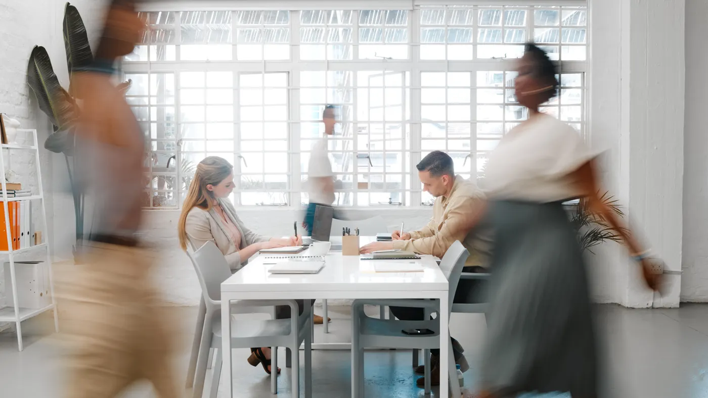 Business people walking in a creative workplace.