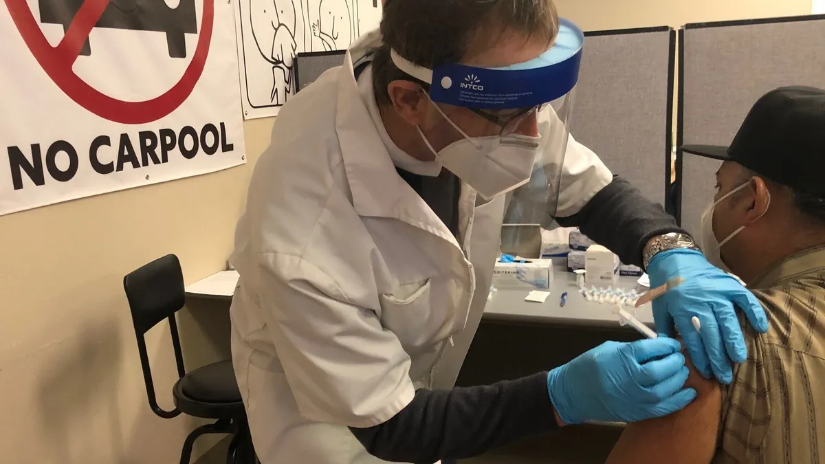 A Foster Farms employee in Fresno, California receives a COVID-19 vaccine at a clinic at the plant in February 2021.