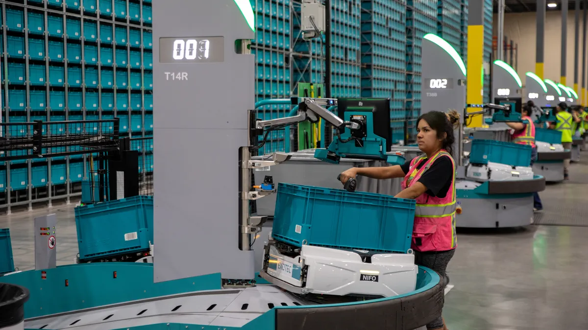 Women working in warehouse with machinery