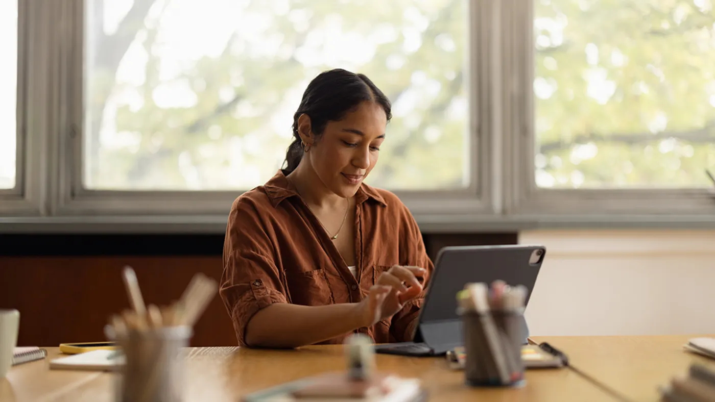 Person working on tablet at table