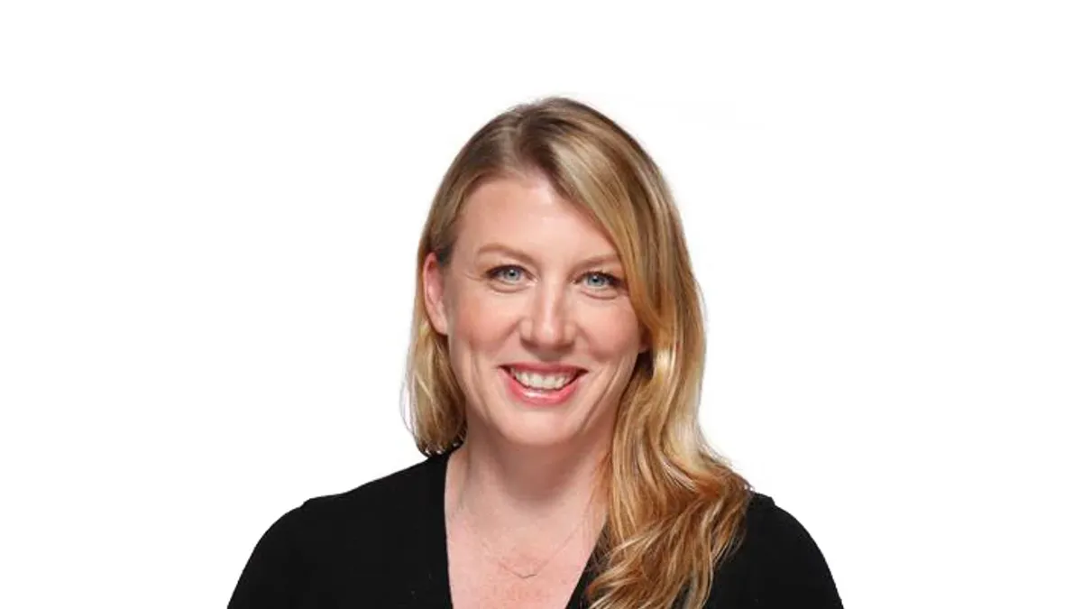 A headshot of a blonde person on a white background.