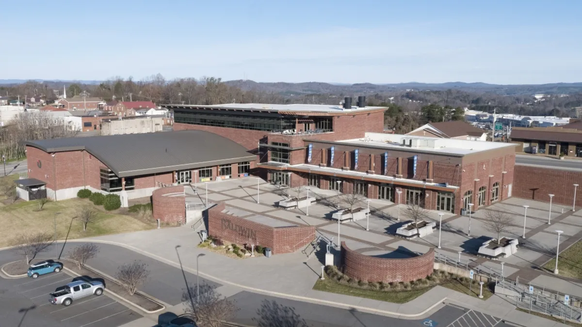 An aerial photo shows brick buildings.