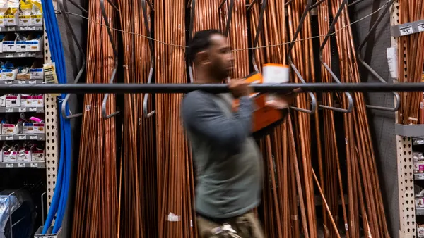 Man carries copper pipes