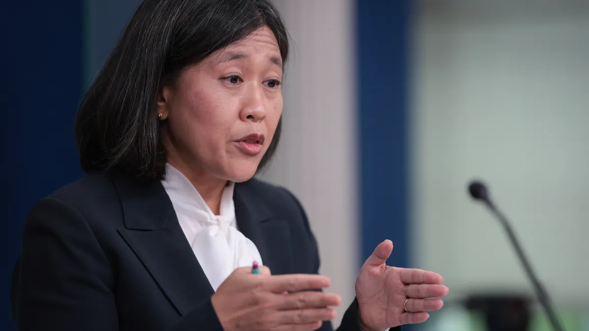 U.S. Trade Representative Katherine Tai speaks into a microphone at a White House press briefing