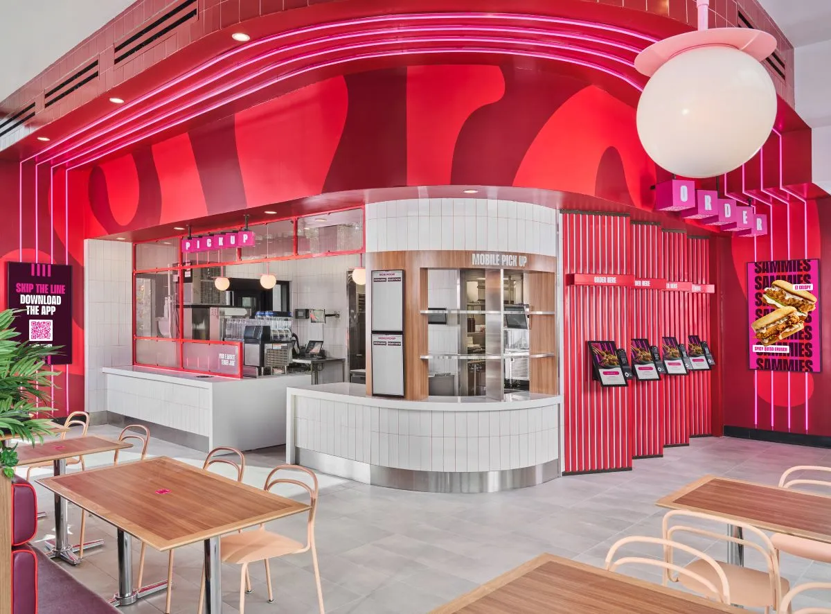 Inside Saucy by KFC with pink interiors and kiosks