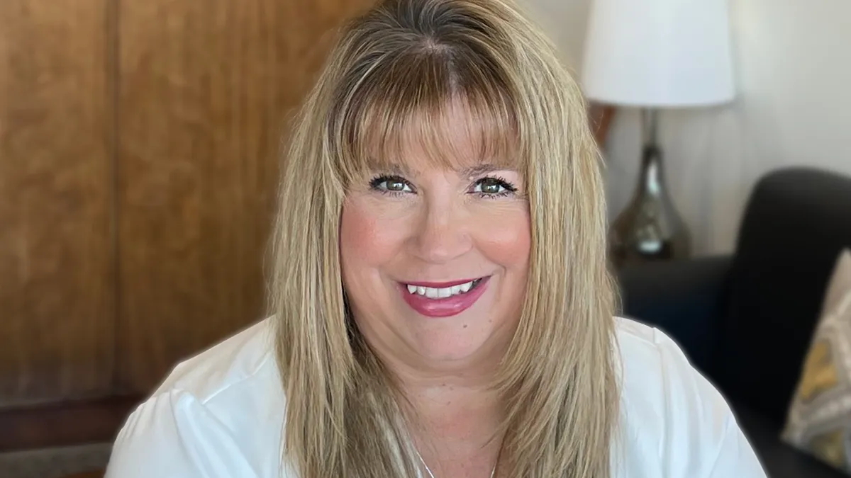 Baxter's Heather Knight is pictured with a lamp and sofa in the background.