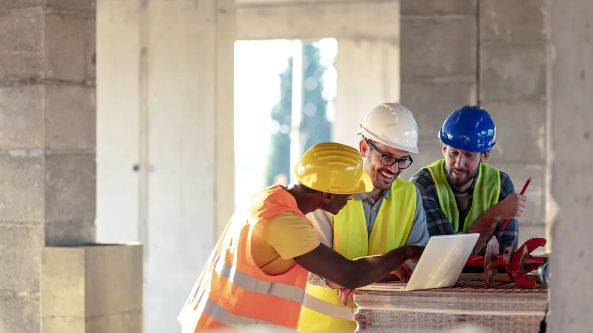 Multi-ethnic construction workers wearing protective helmets and vests