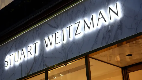 A closeup of the Stuart Weitzman name on a storefront.