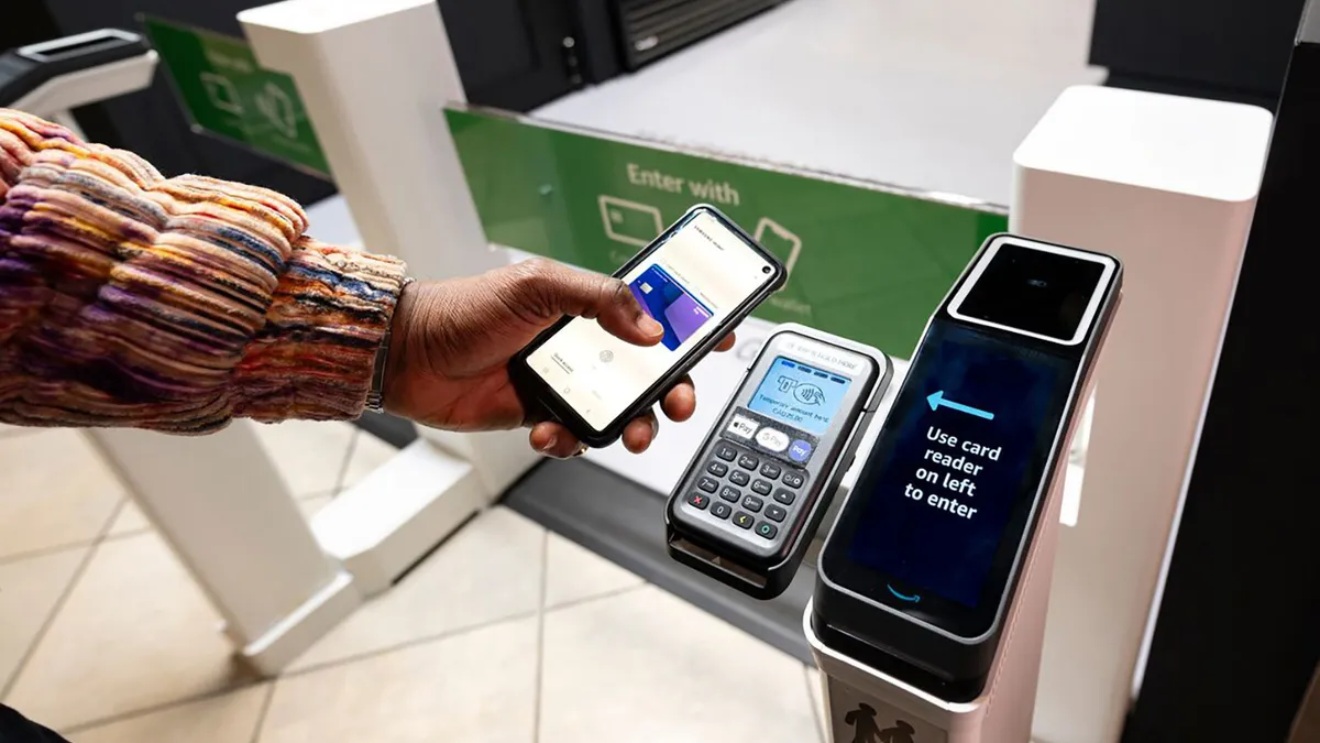 A customer scanning their phone at an Amazon Just Walk Out terminal