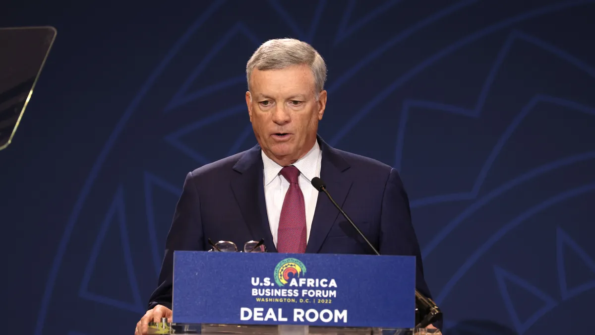 Visa Chairman Al Kelly stands at podium with sign saying "U.S. Africa Business Forum" in Washington, DC.