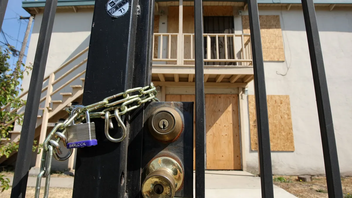 a boarded up gate in front of an apartment