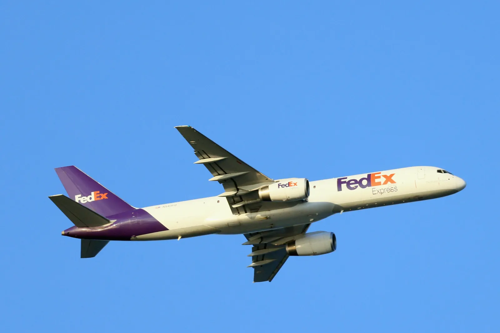 A Federal Express cargo plane flies over Nickerson Beach on July 20, 2022 in Lido Beach, New York, United States.