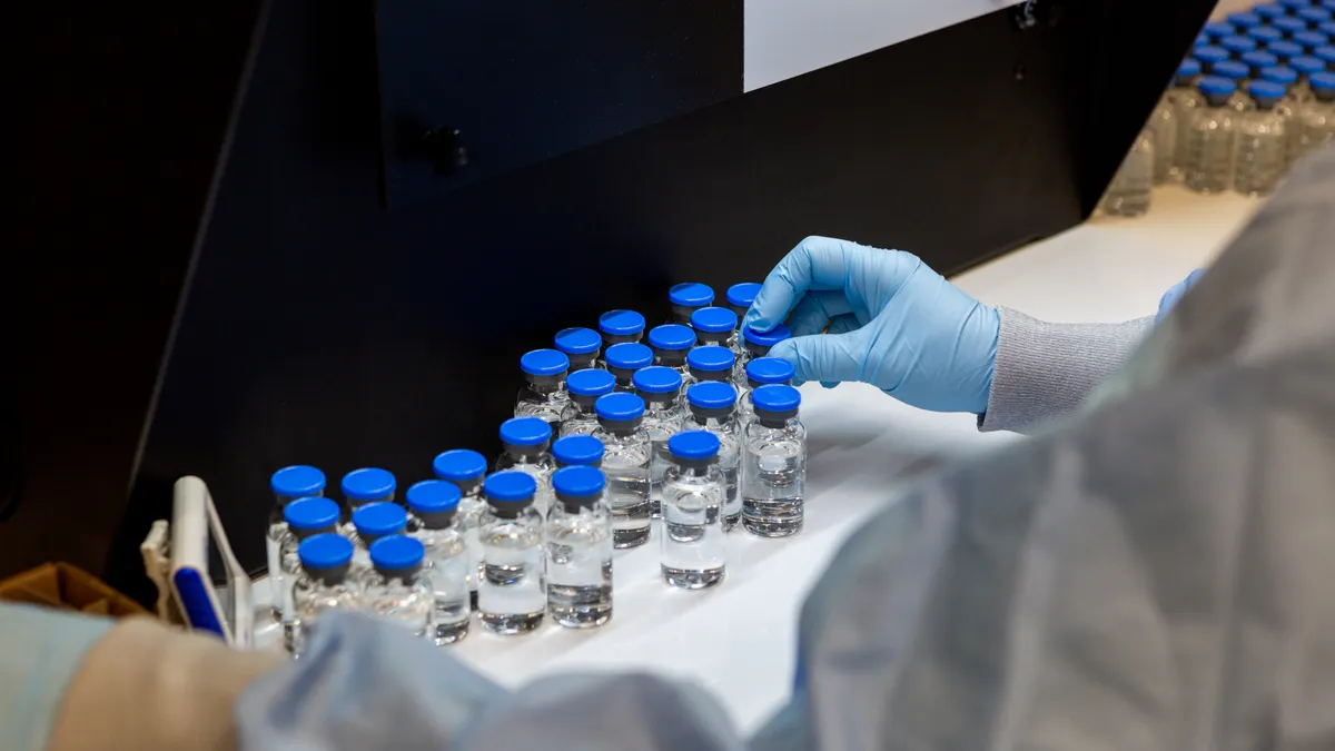 Visual inspection process for investigational remdesivir, photo by Gilead Sciences