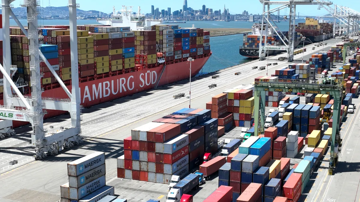 In an aerial view, a container ship sits docked at the Port of Oakland on May 20, 2022.