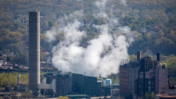Plumes of steam emerge from a power plant.