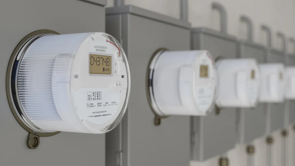A row of electric utility meters on a wall.