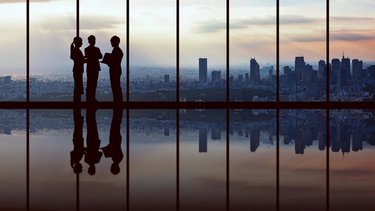 Businesspeople in front of urban cityscape