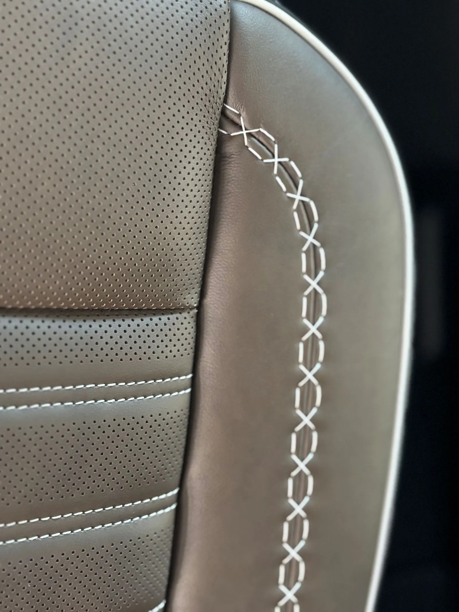 A close-up of the plaited stitching on the seats of the 2026 GMC Acadia Denali Ultimate.