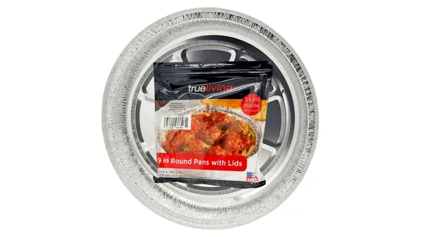 A round aluminum food tray has a pouch in it with folded lids.
