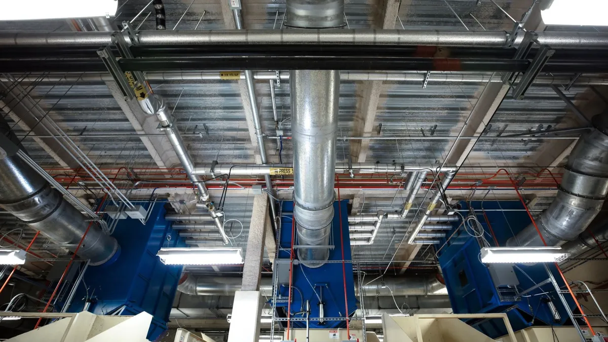 Metal tubes hanging from ceiling