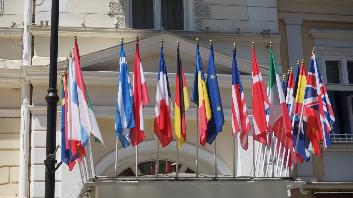 Flags of different countries hanging outside of a building