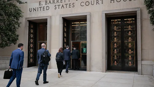 People walking into a building.