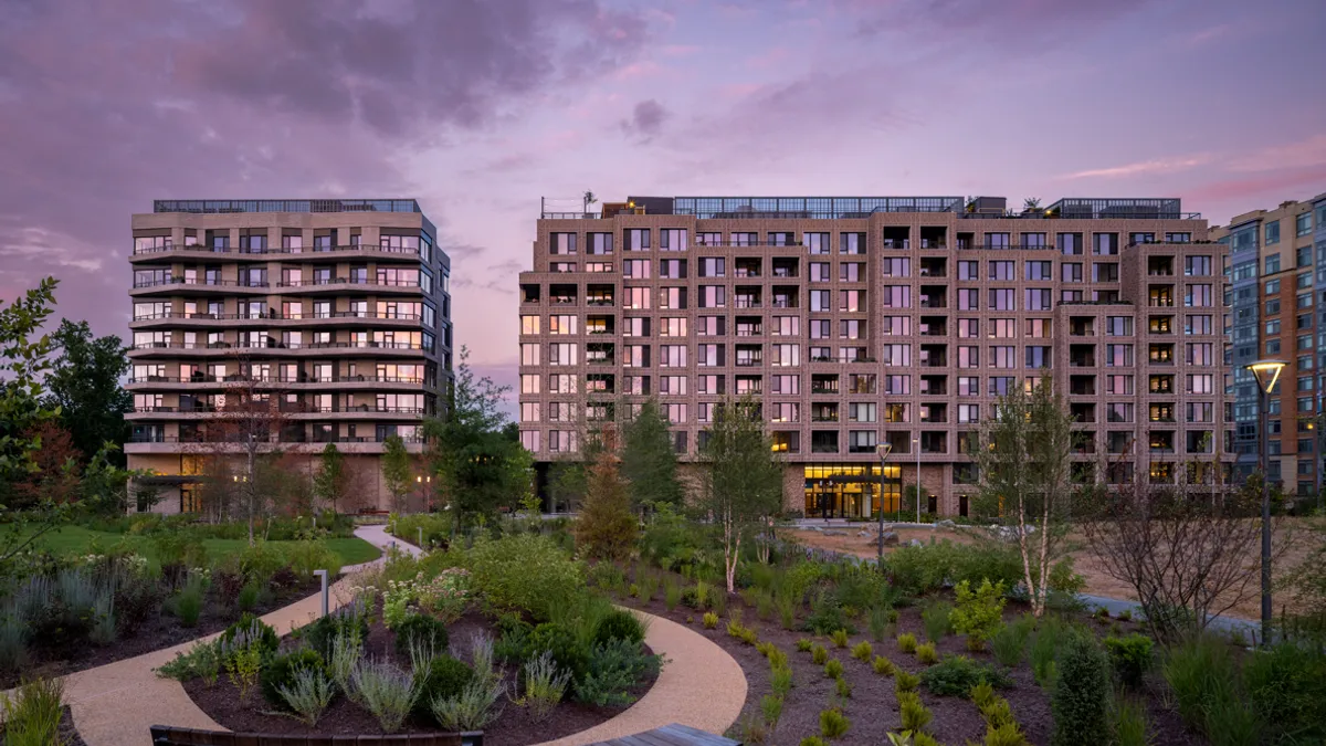 Two buildings on the edge of a park.